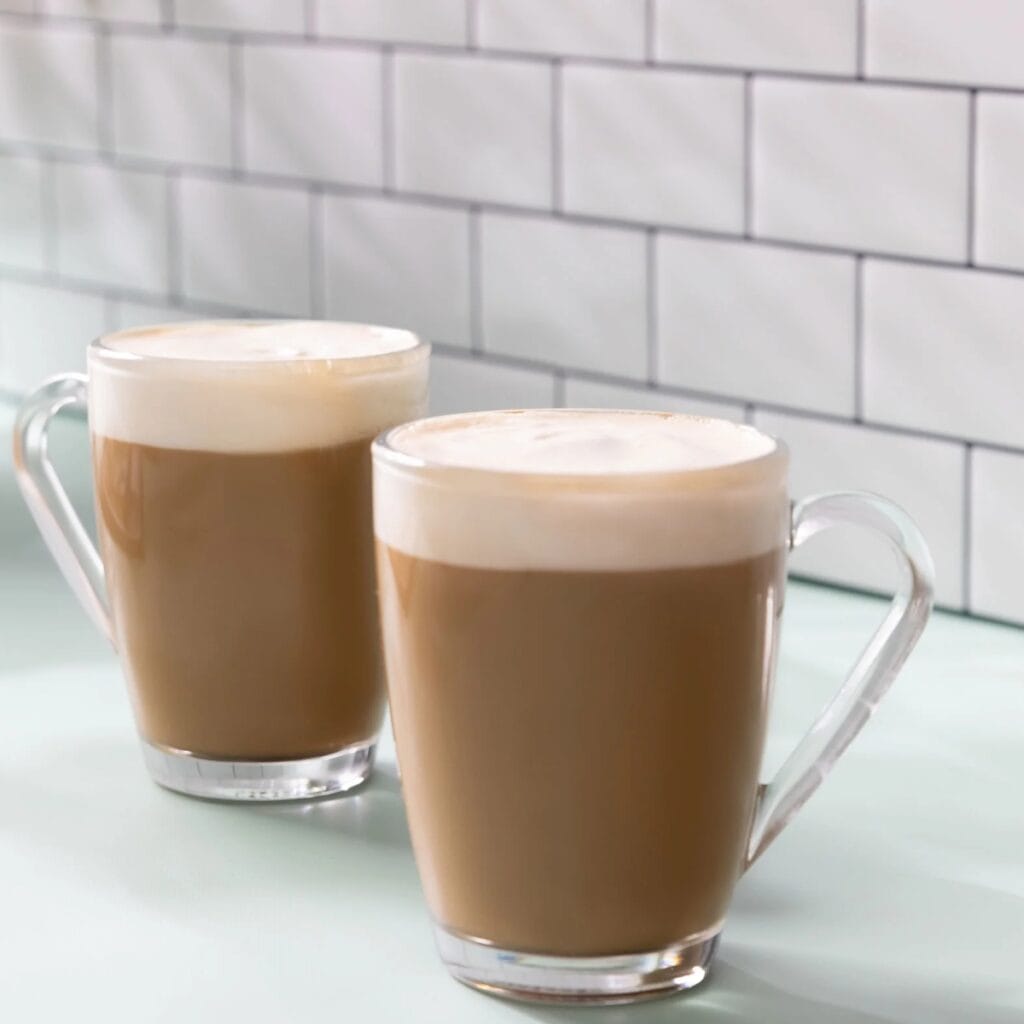 Two Glass Mugs of Starbucks Caffè Latte