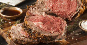 Sliced prime rib steak on a cutting board.